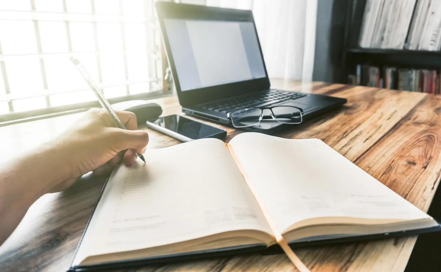 Closeup shot of a person writing in a journal