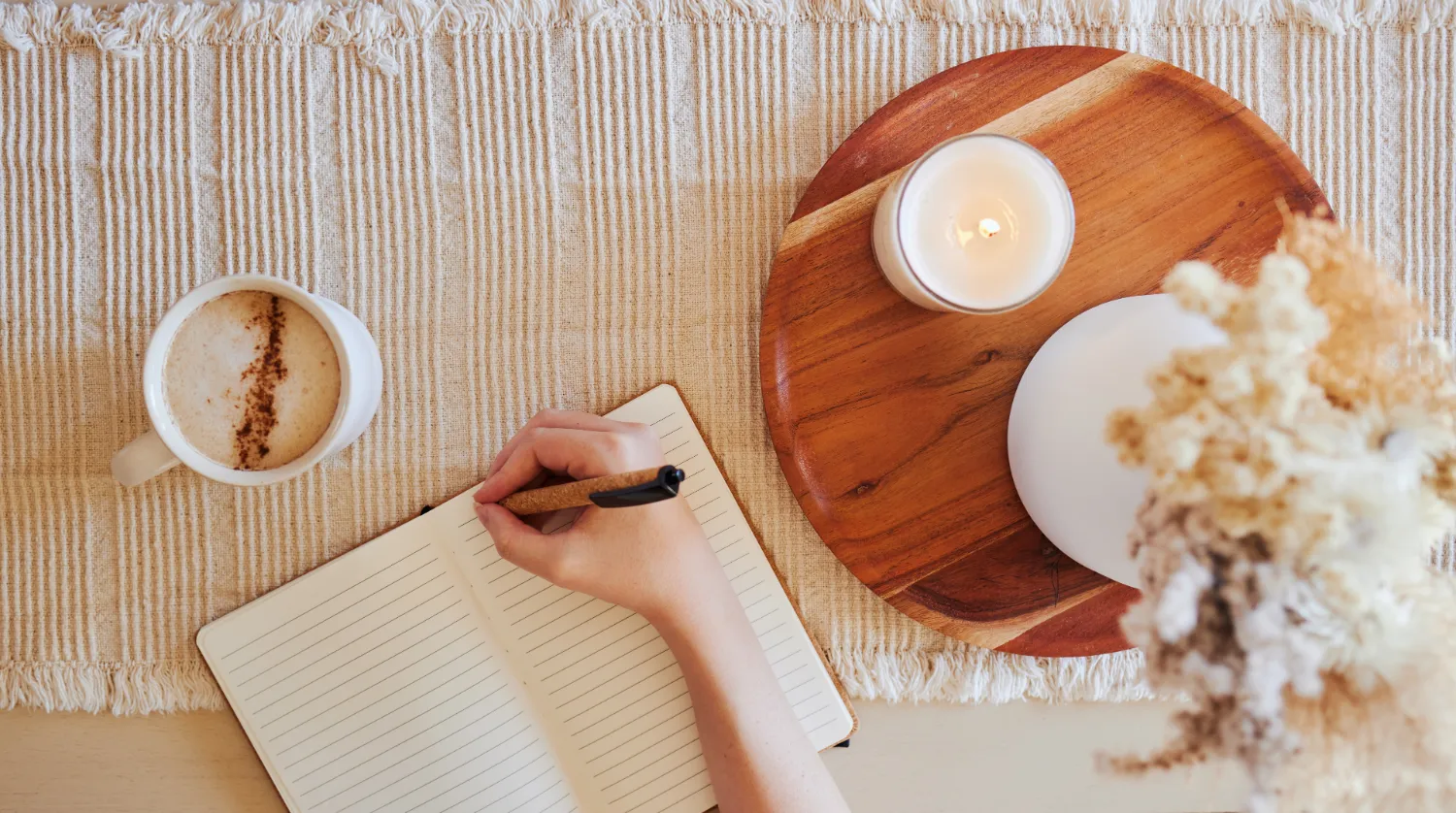 Coffee hand and writing in journal