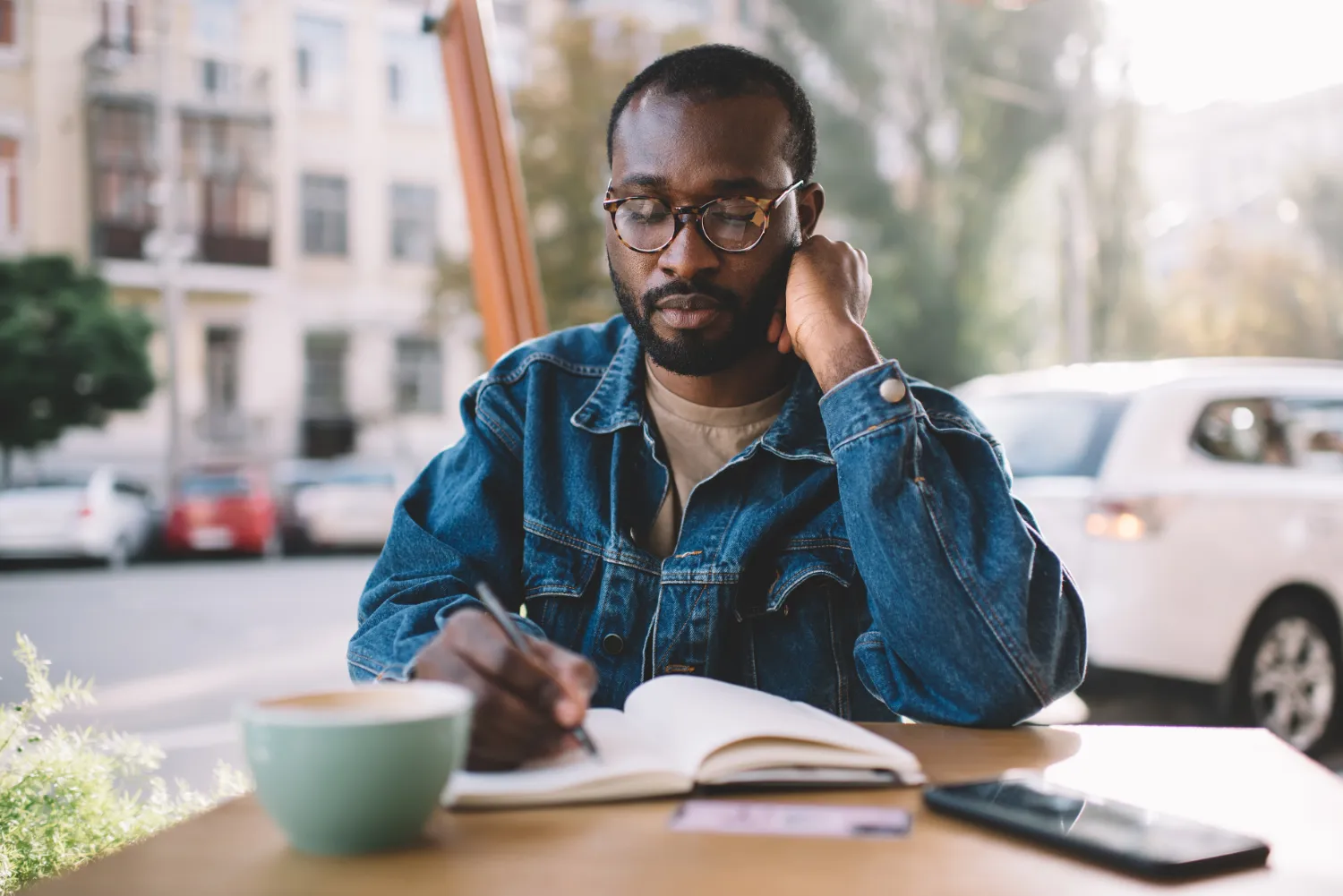 Male student writing in journal