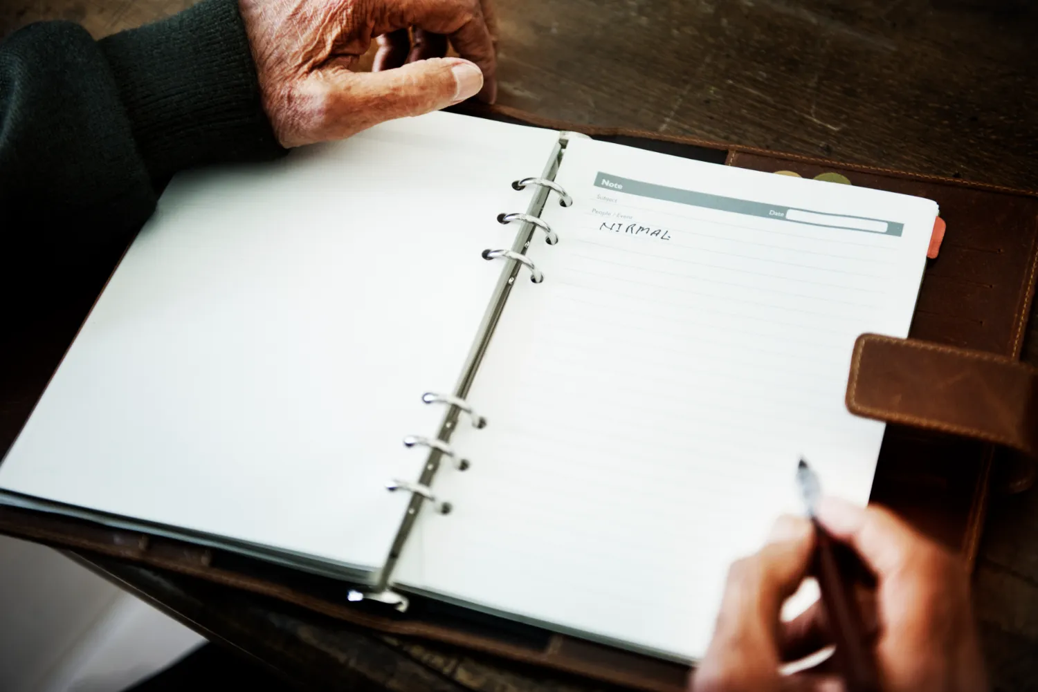 Senior person handwriting a journal