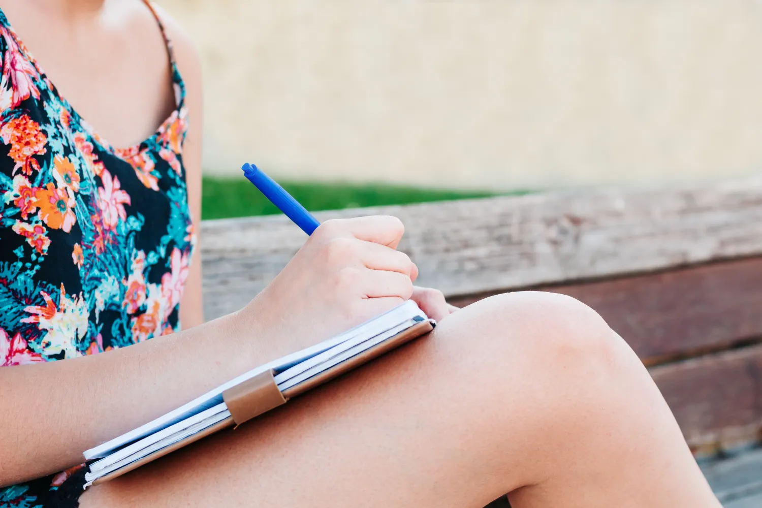 Young girl with pencil writing in notebook