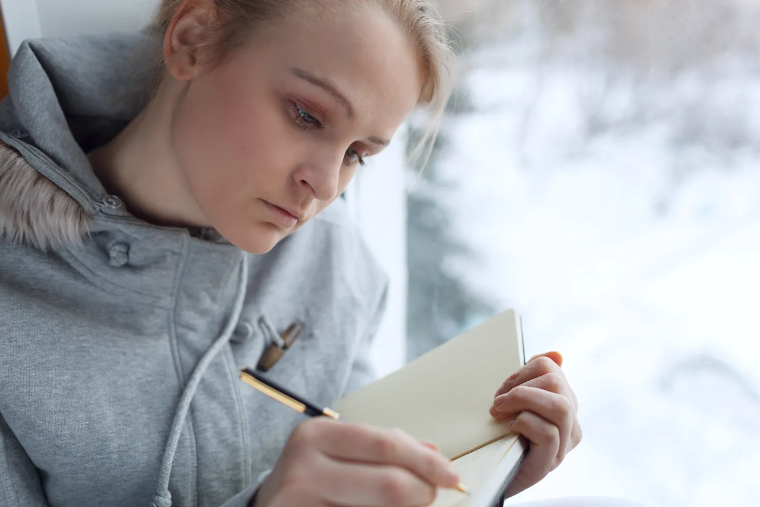 Young girl writing in her journal